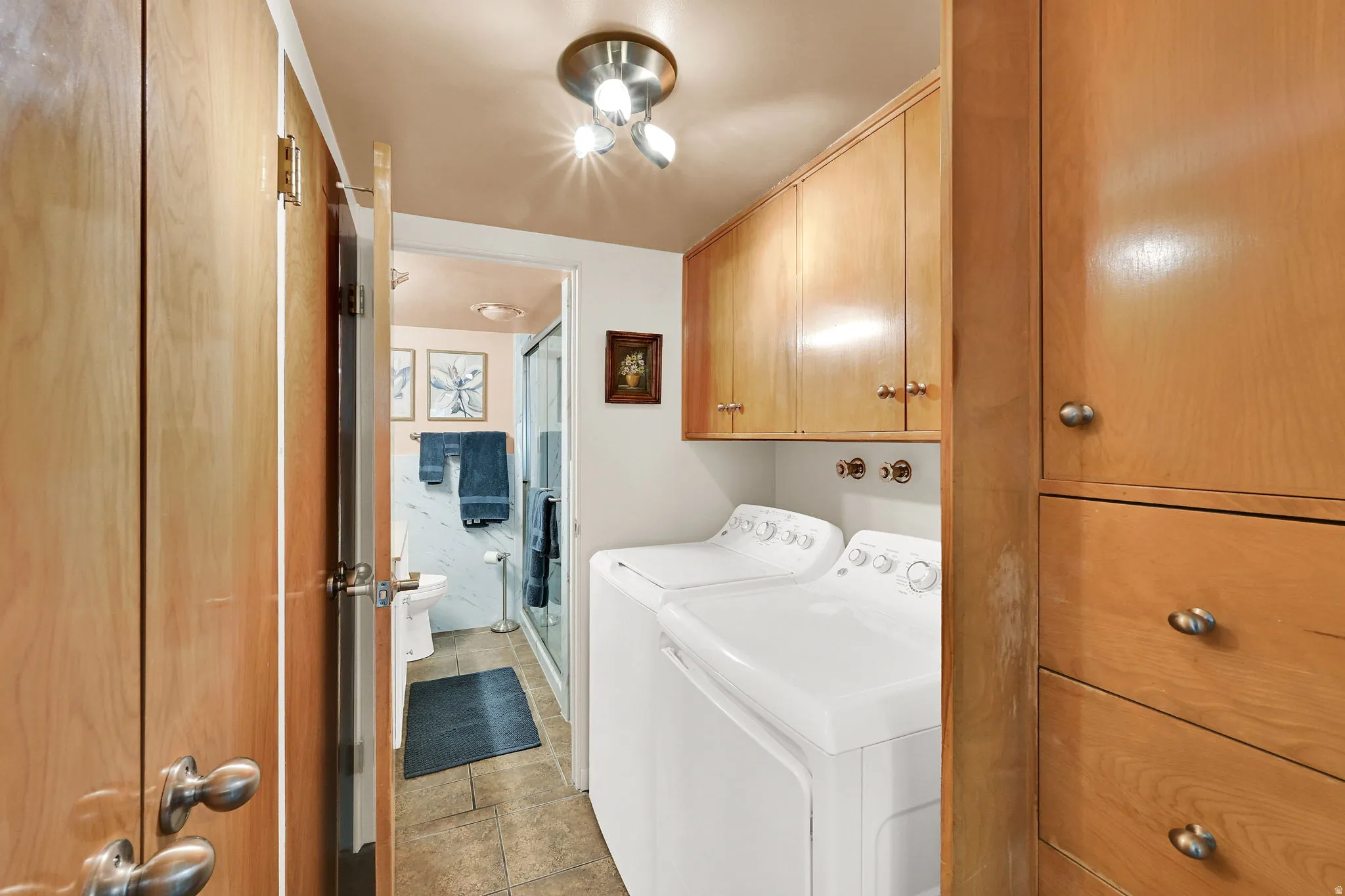 Laundry room featuring cabinet space and washing machine and clothes dryer