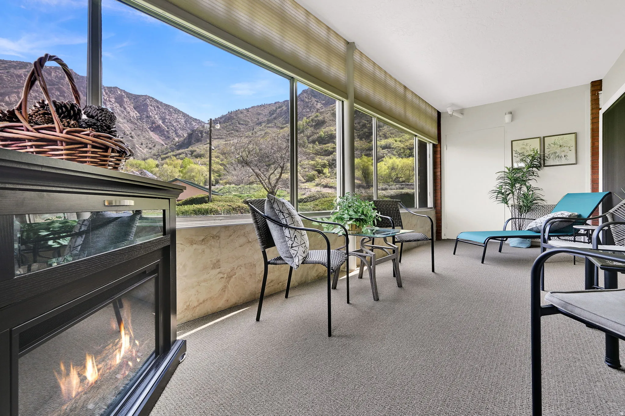 Sunroom / solarium with a mountain view and a glass covered fireplace