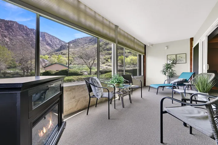 Sunroom / solarium with a mountain view and carpet flooring