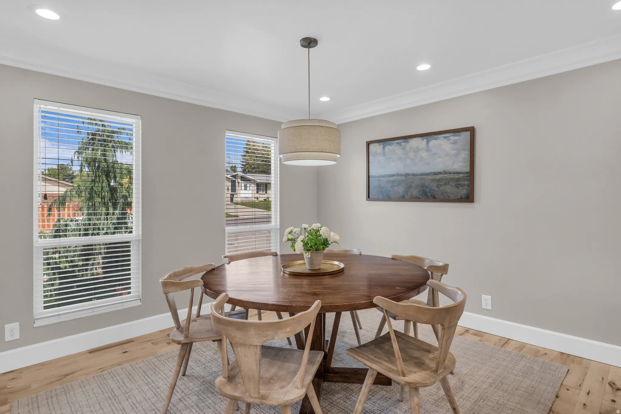 Dining room featuring recessed lighting, light wood finished floors, and ornamental molding