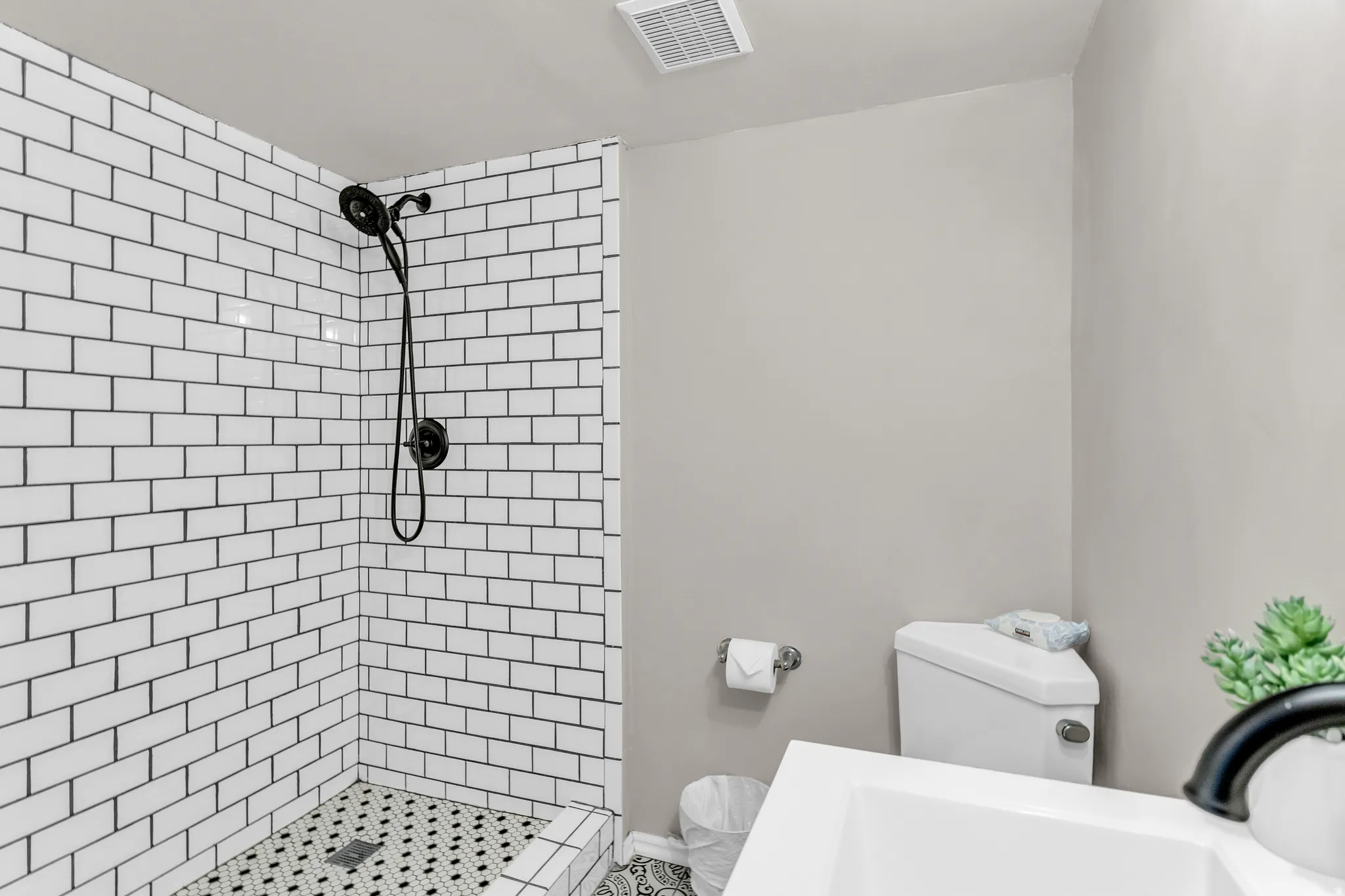 Bathroom featuring toilet and a stall shower