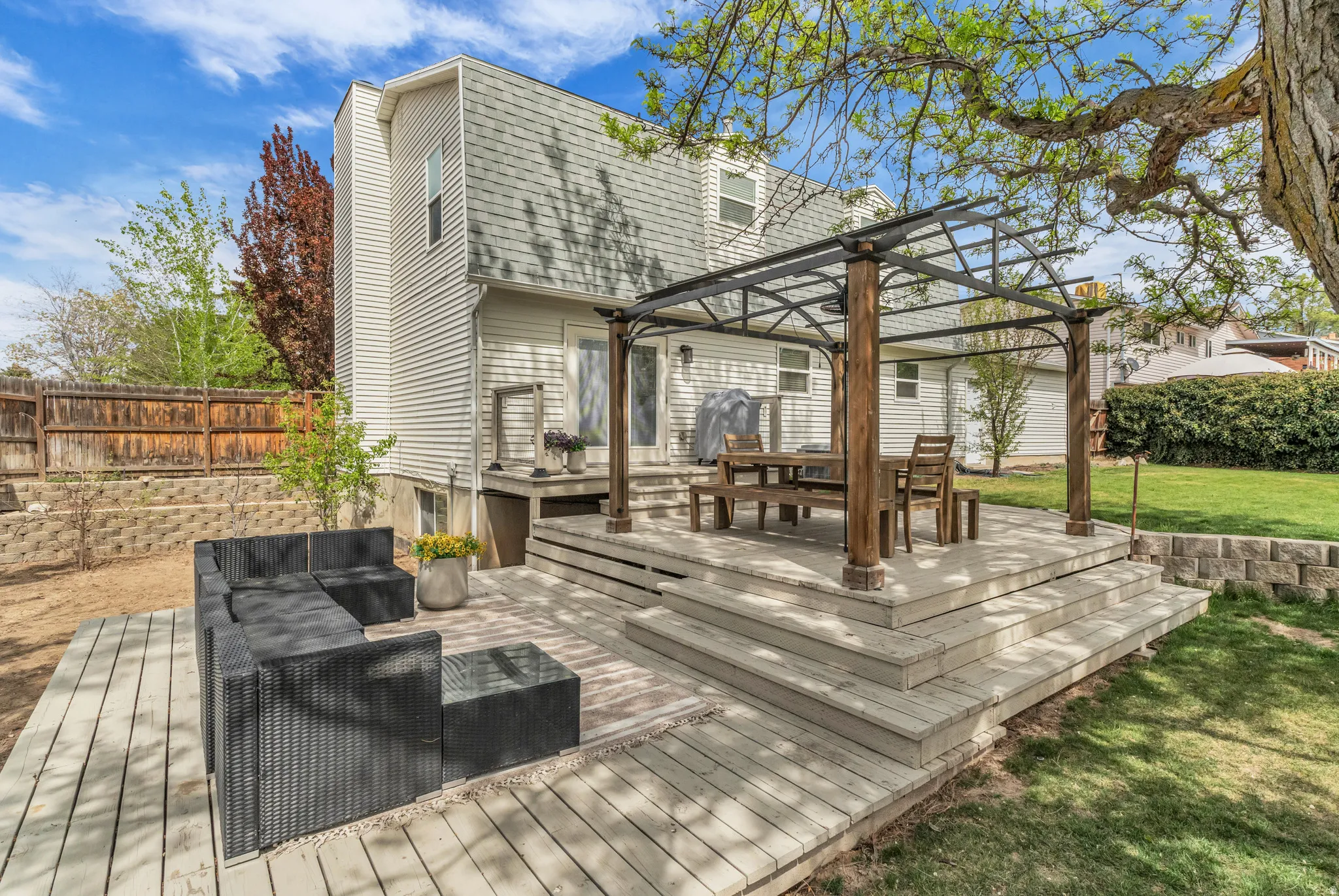 Wooden deck featuring an outdoor living space. Fruit trees and garden.