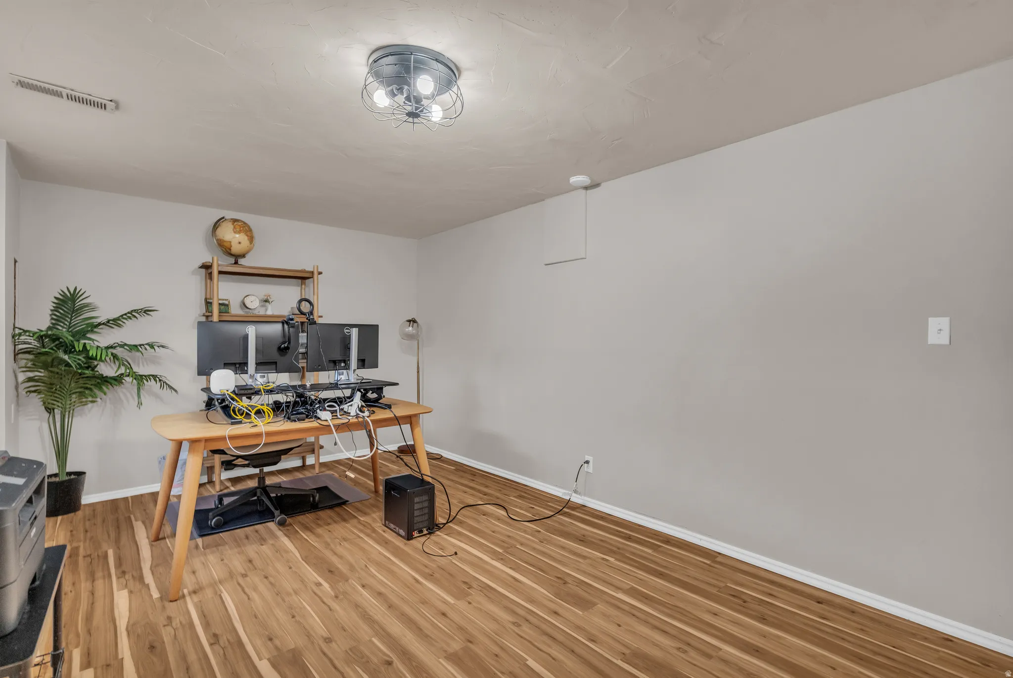 Used as Home office featuring light wood finished floors and baseboards. Can be a bedroom.