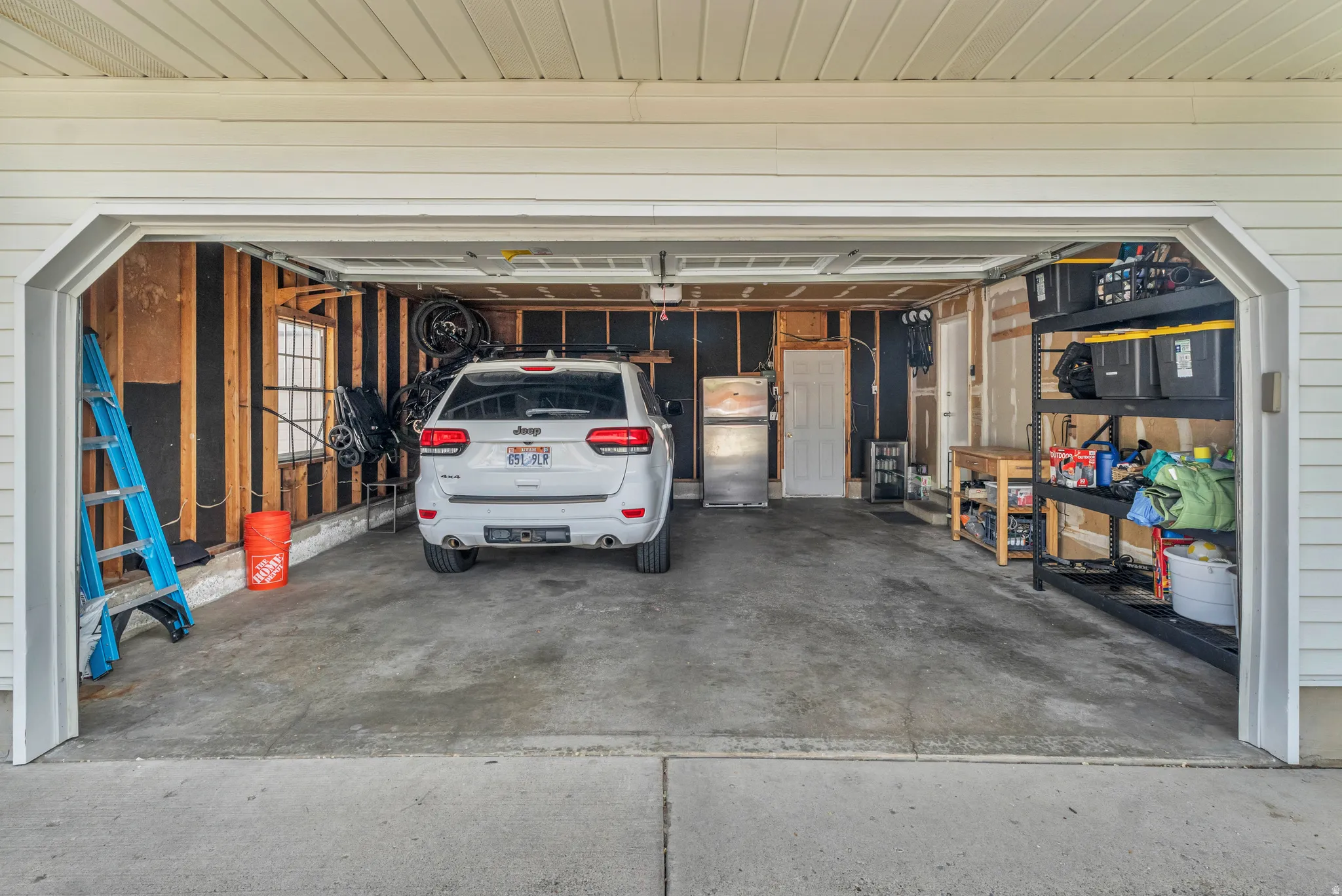 Garage featuring freestanding refrigerator