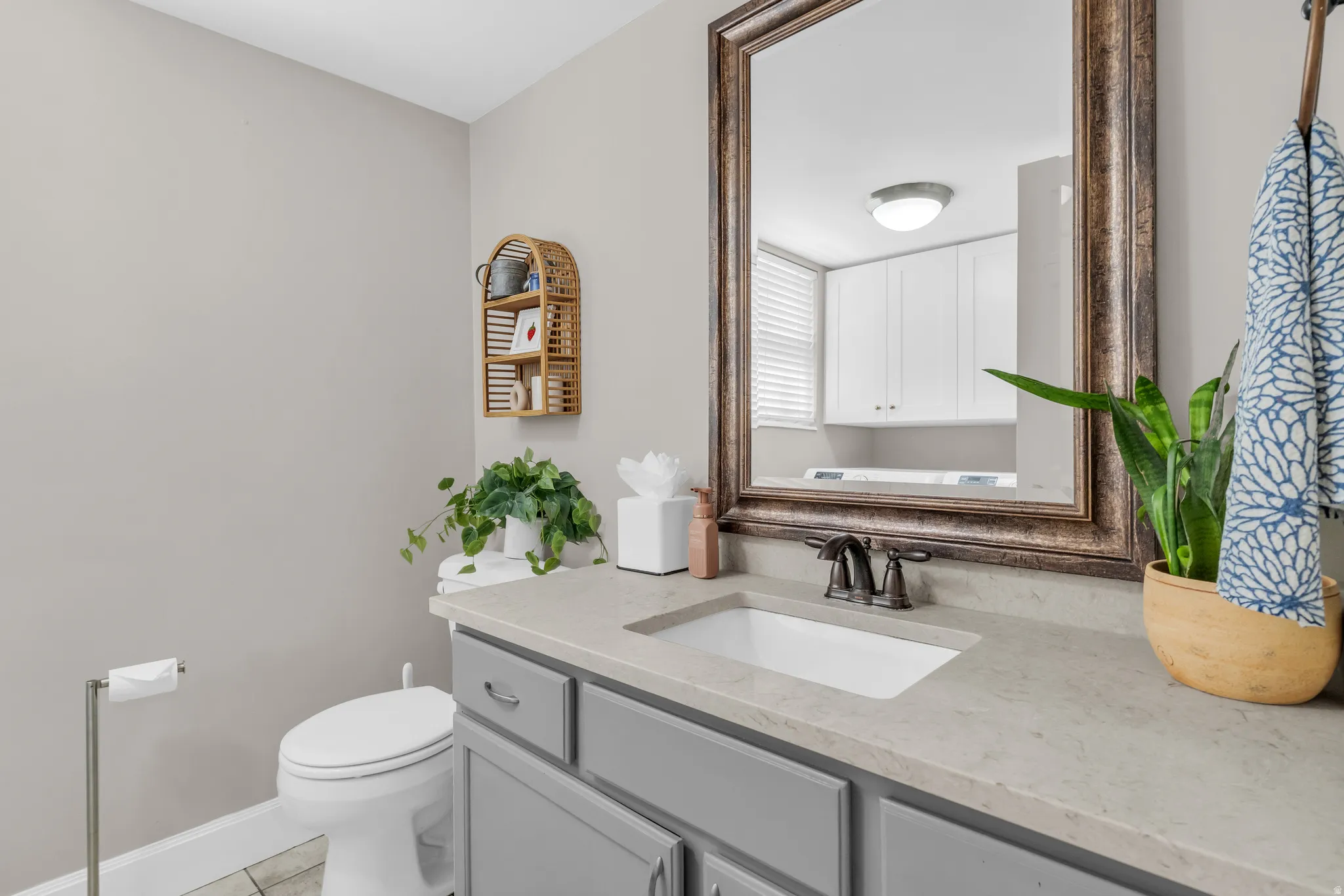 Half bath featuring vanity and light tile patterned floors