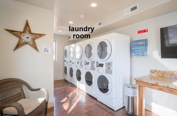 Community laundry room featuring stacked washer and clothes dryer, washer and clothes dryer, and recessed lighting