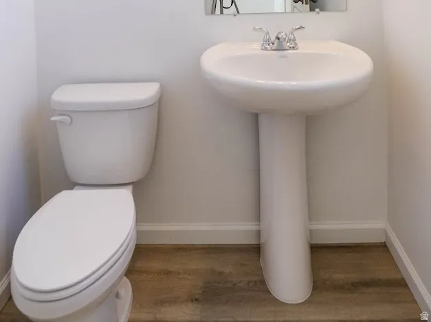 Bathroom with wood finished floors and baseboards