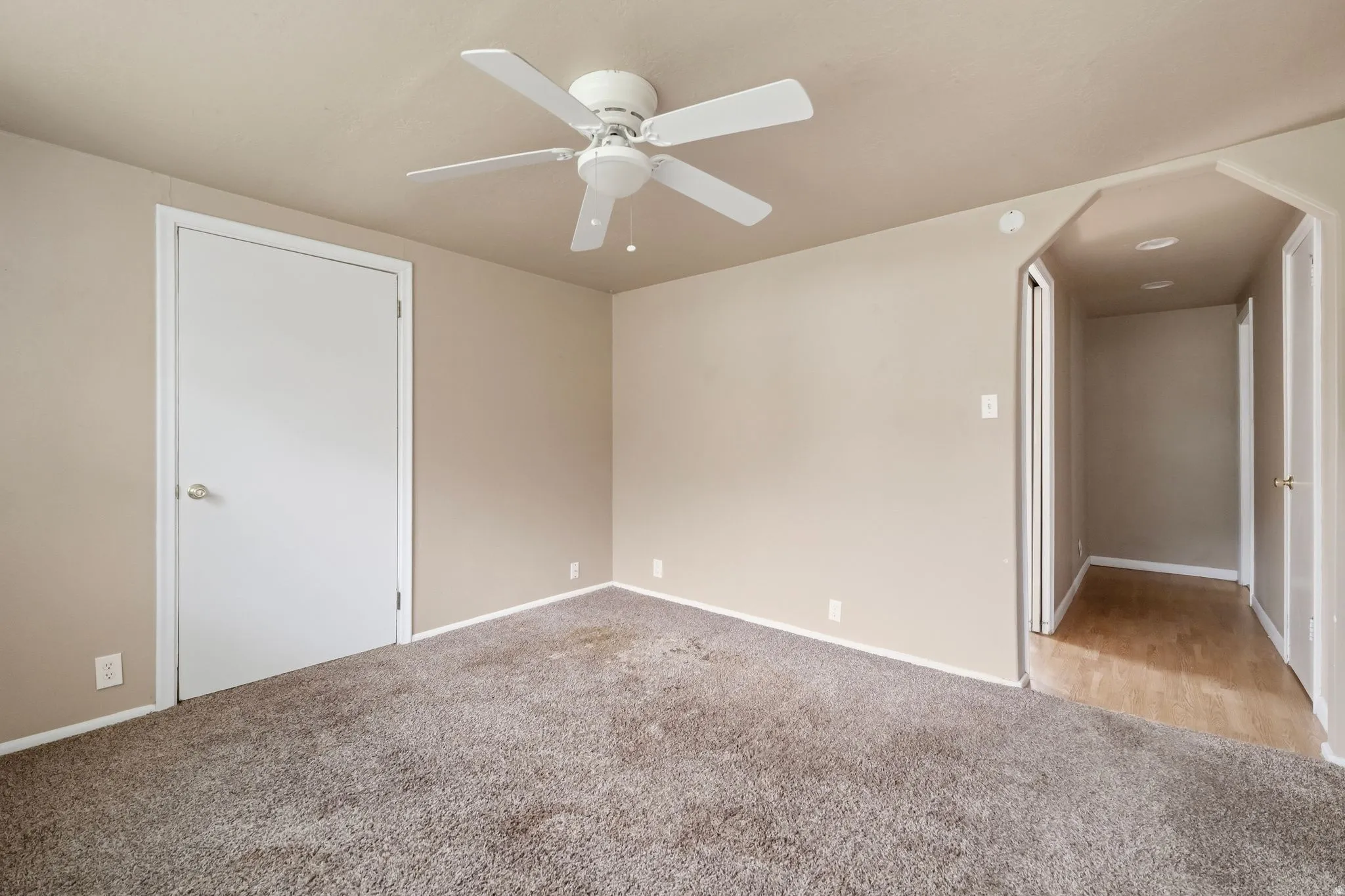 Unfurnished bedroom featuring carpet and a ceiling fan