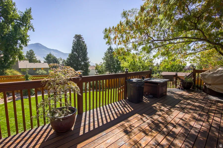Wooden terrace with a yard, a mountain view. Back fence has double gate to access common park area and walking paths. May be used for vehicle access
