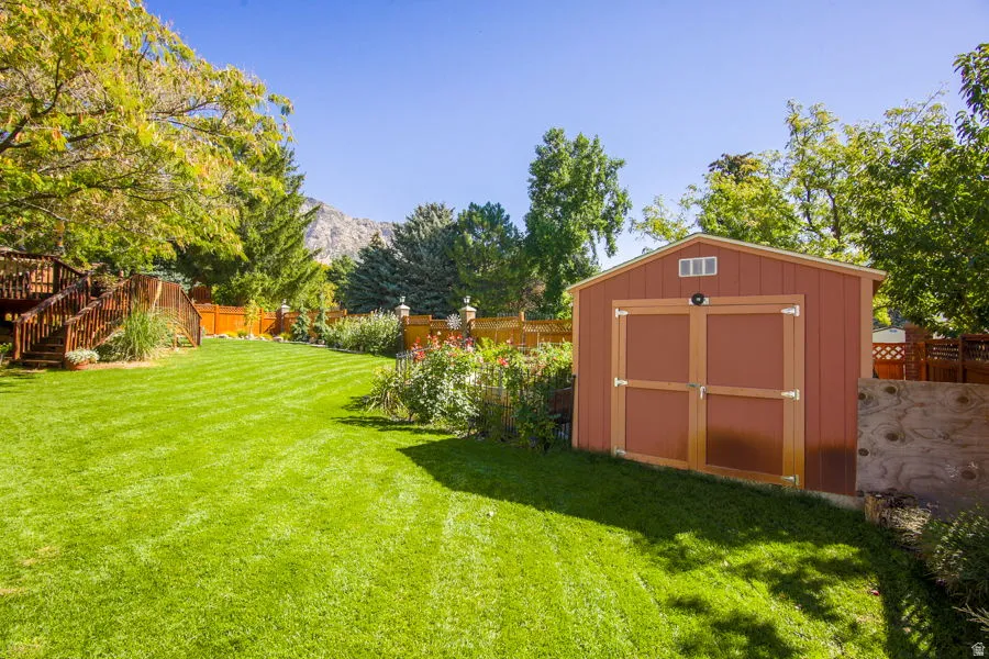 View of backyard from west side. Good size garden with raised beds with fencing. Garden shed. Open space back