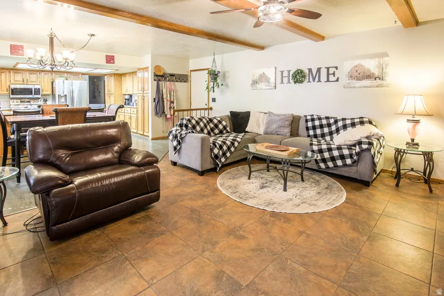 Reverse view of great room. Also showing tiled entry off of garage access. Family room to dining with full size table