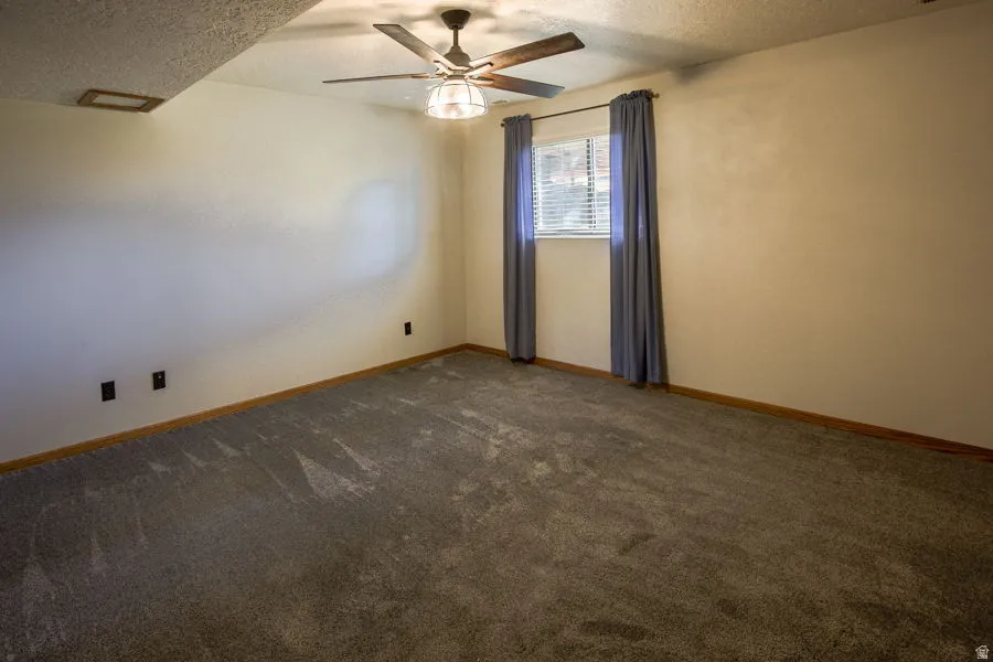 4th bedroom, has above ground window to backyard, ceiling fan and mirrored closet doors