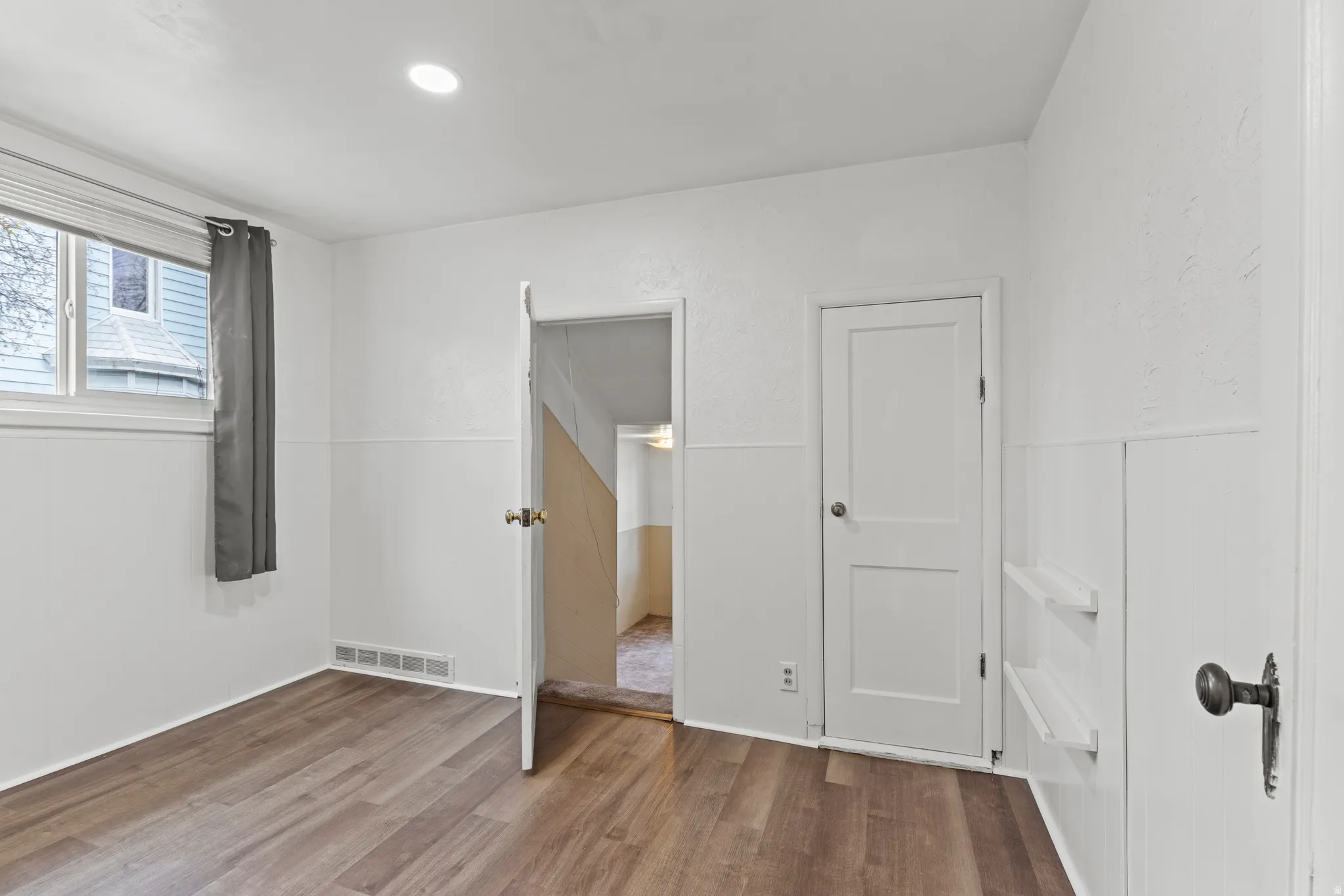 Unfurnished bedroom with vinyl floors and recessed lighting