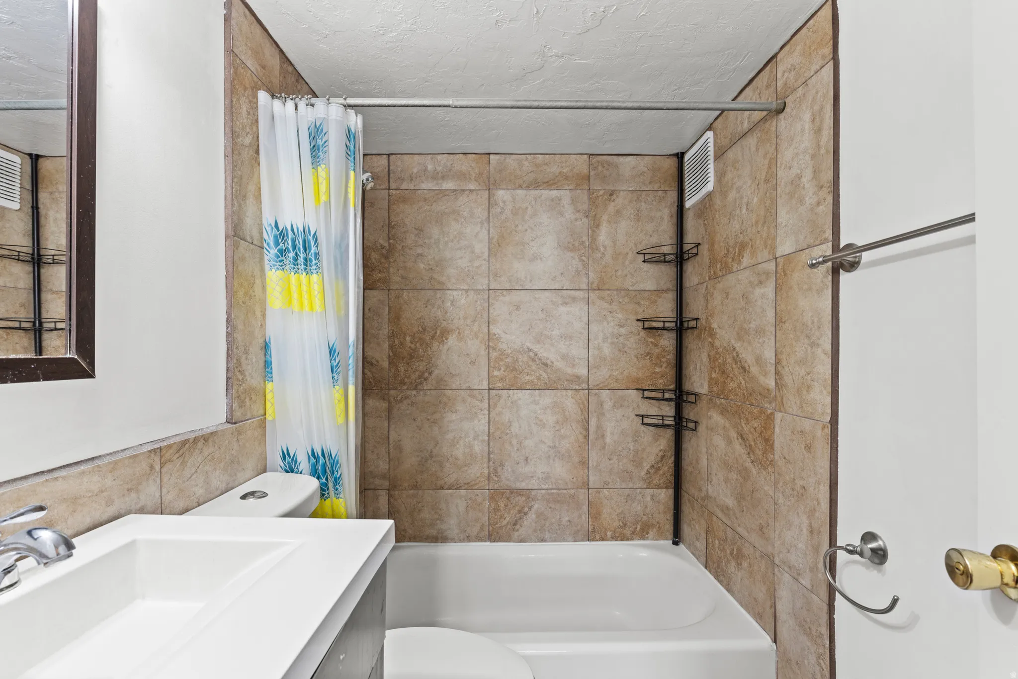 Full bath with vanity, shower / bathtub combination with curtain, and a textured ceiling
