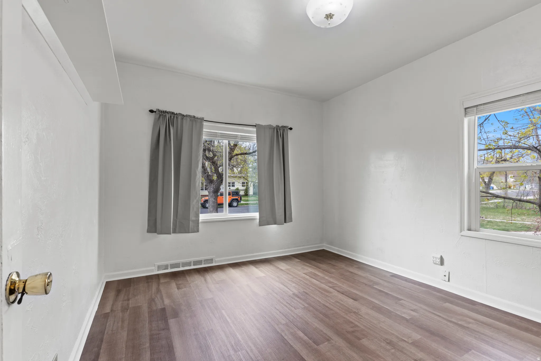 Empty room featuring vinyl floors and baseboards