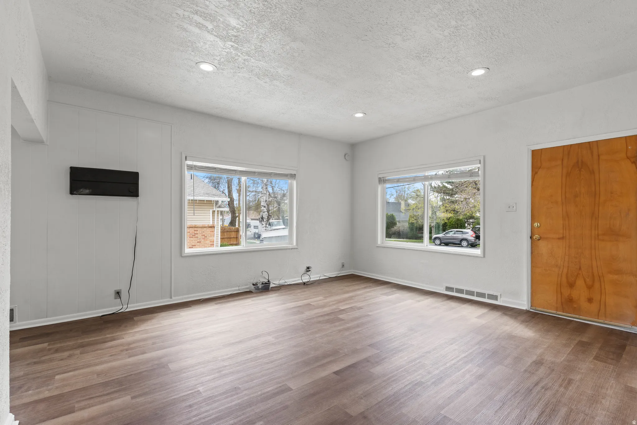 Entrance foyer featuring vinyl floors, healthy amount of natural light, recessed lighting, and a textured ceiling