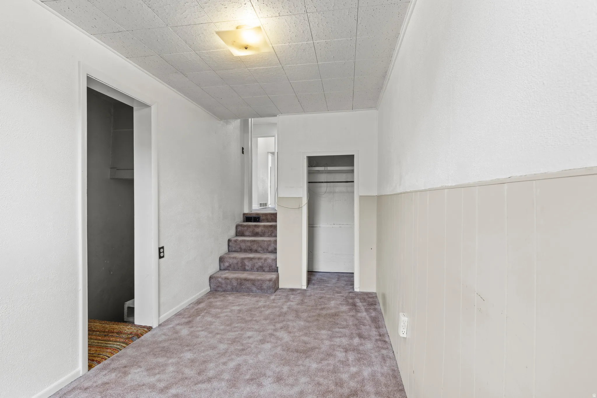 Hall featuring carpet flooring and stairway