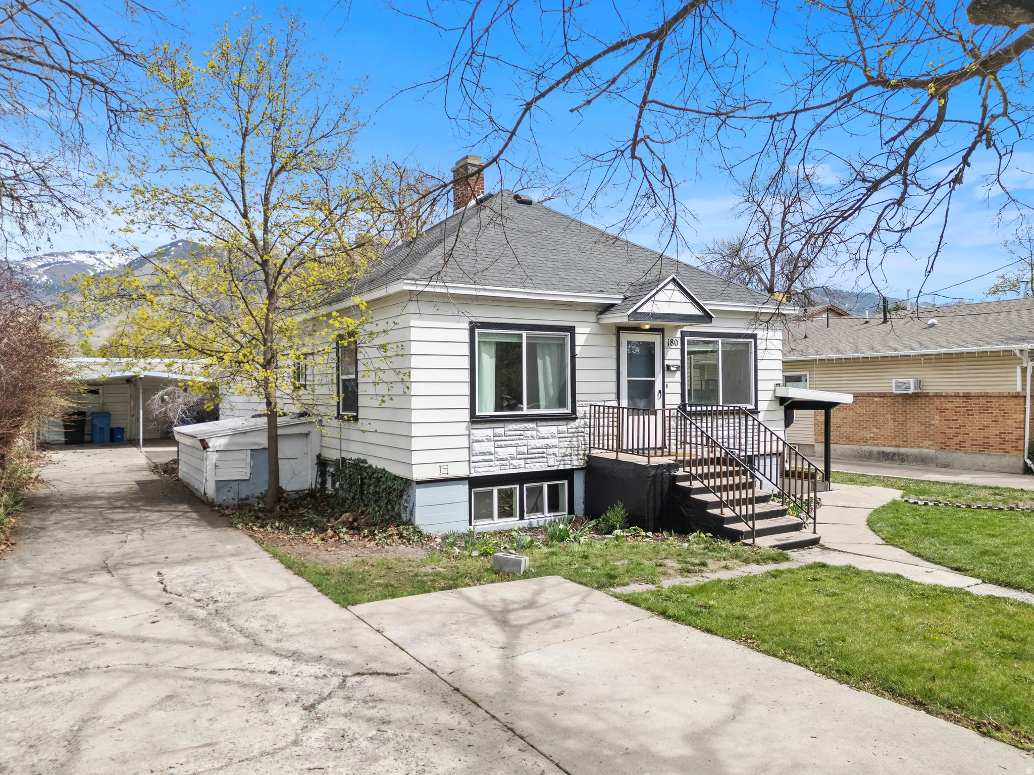 Bungalow with a chimney, roof with shingles, and a front yard
