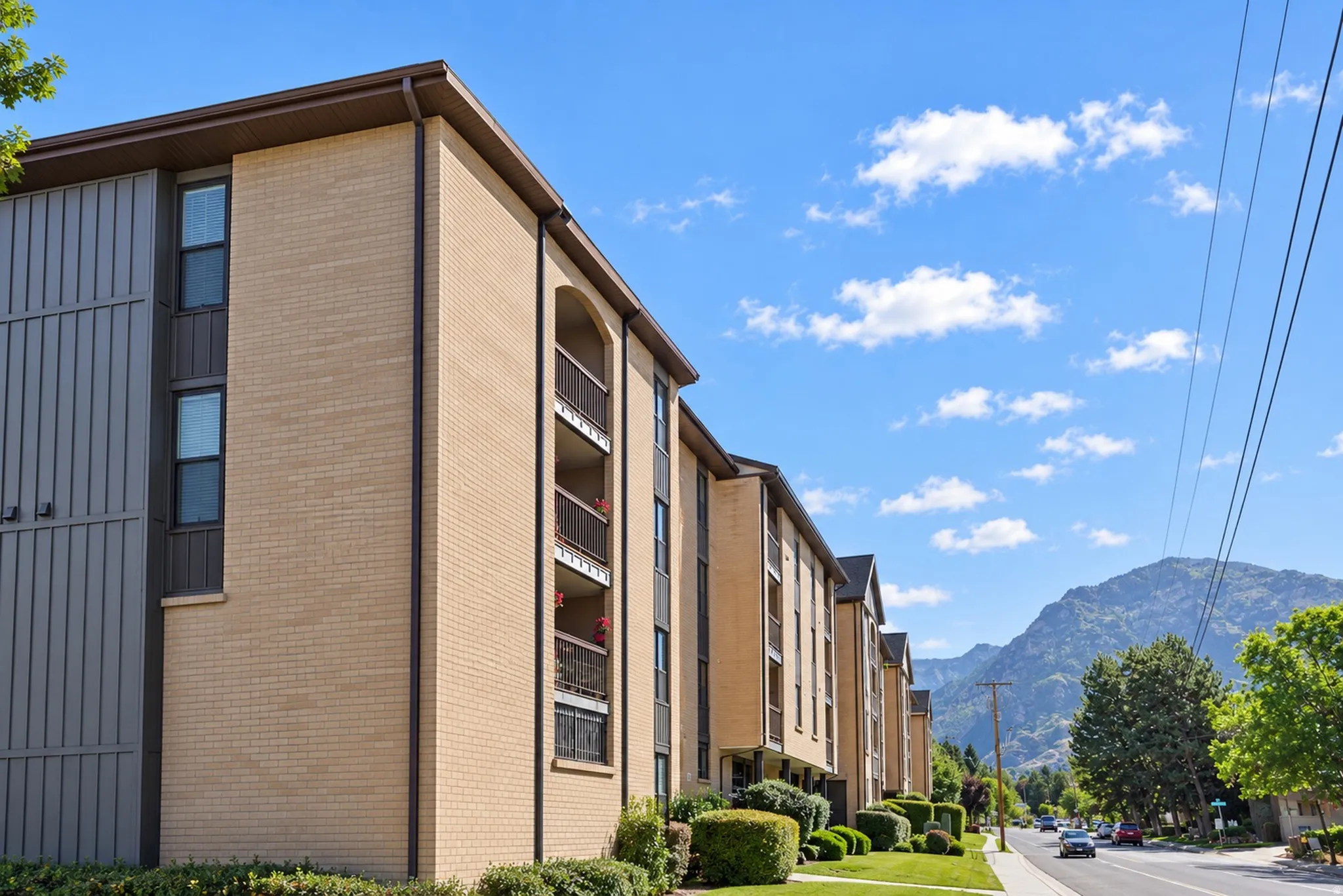 Multi-story building with a light brick exterior and vertical paneling accents