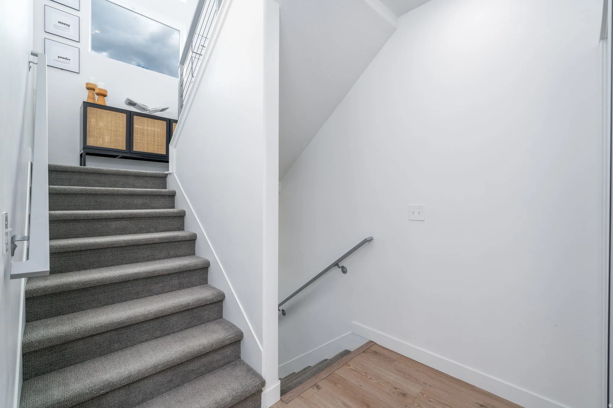 Stairs with wood finished floors and baseboards
