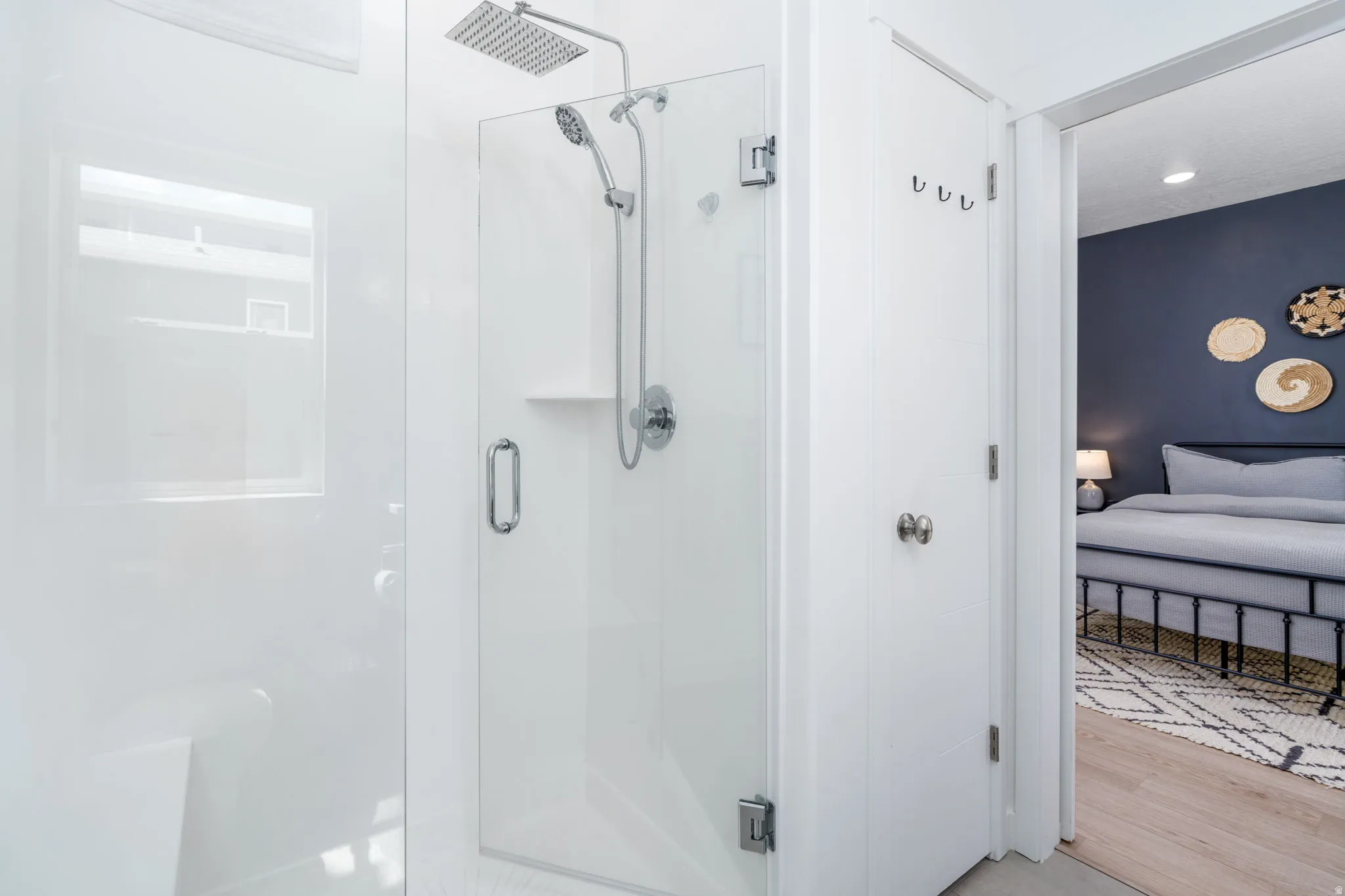 Full bathroom with ensuite bathroom, a stall shower, recessed lighting, and light wood-style floors