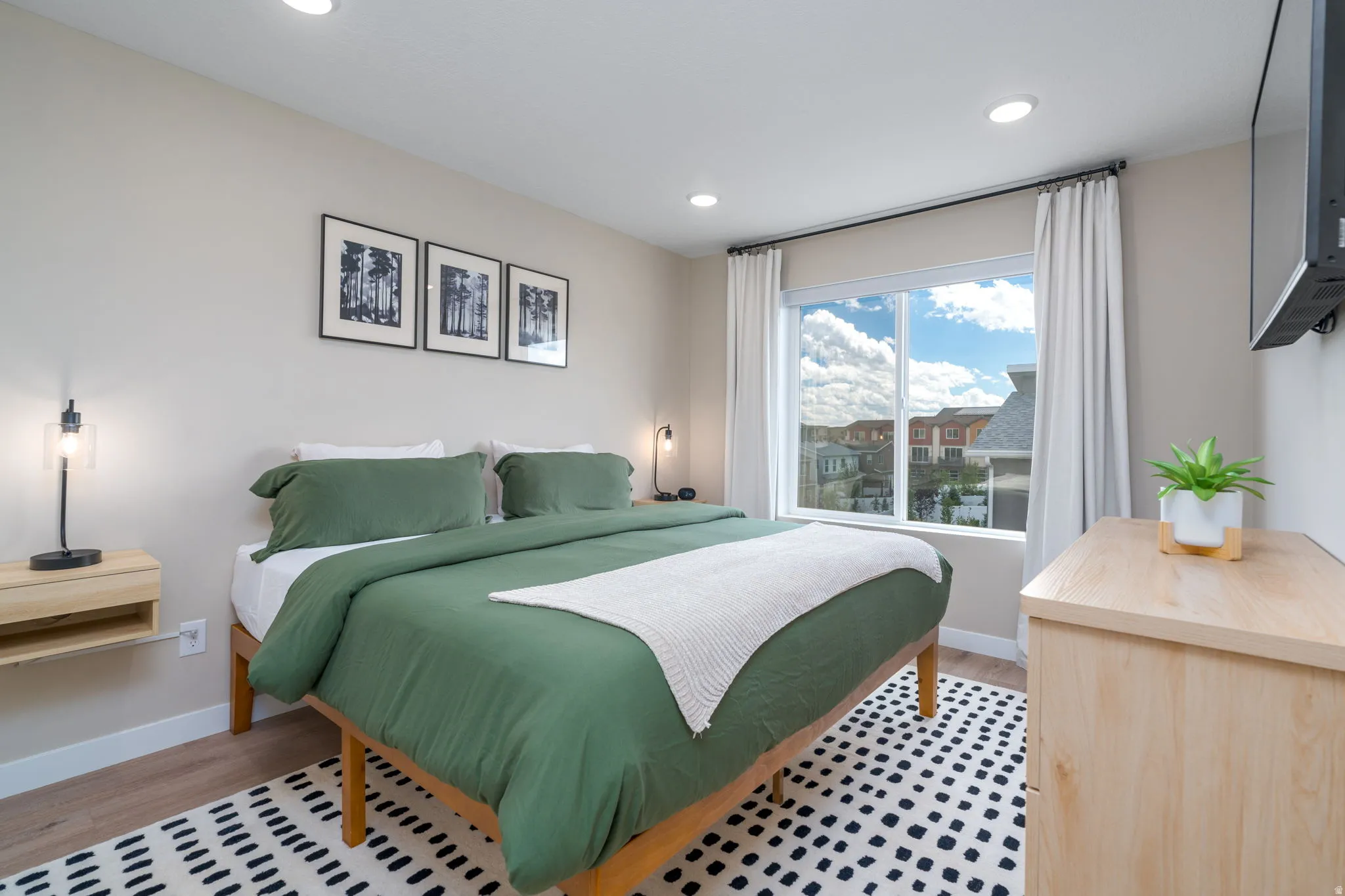 Bedroom with light wood-style floors and recessed lighting