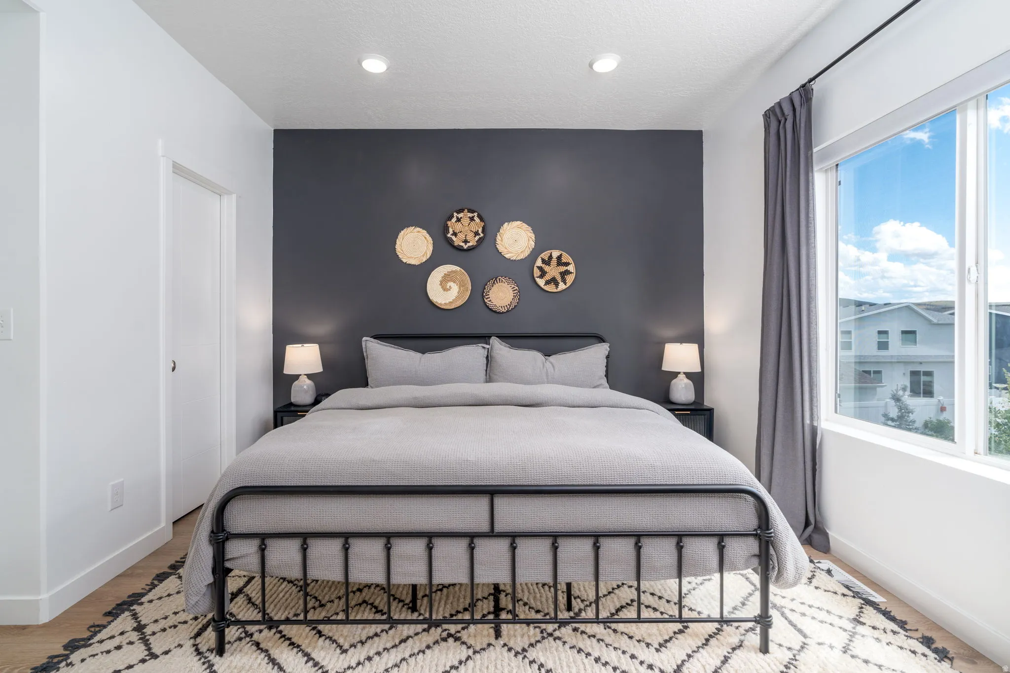 Bedroom featuring baseboards and an accent wall