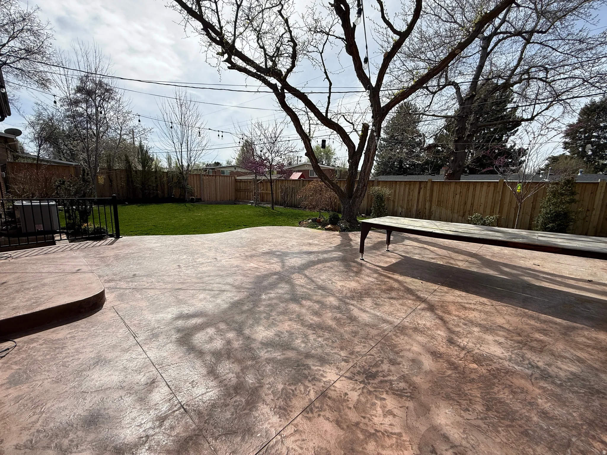 Fenced backyard with a patio