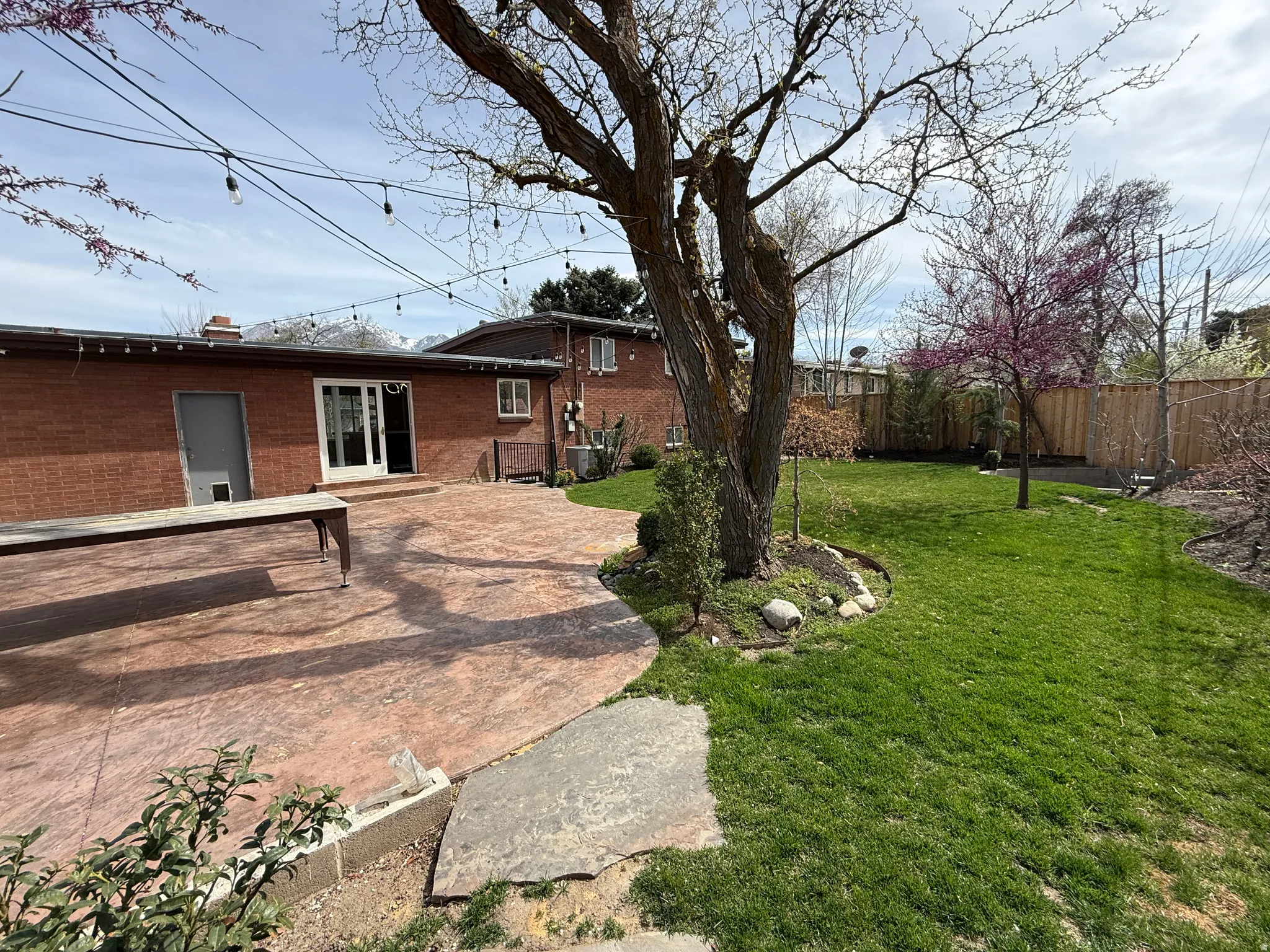 Fenced backyard featuring a patio and french doors