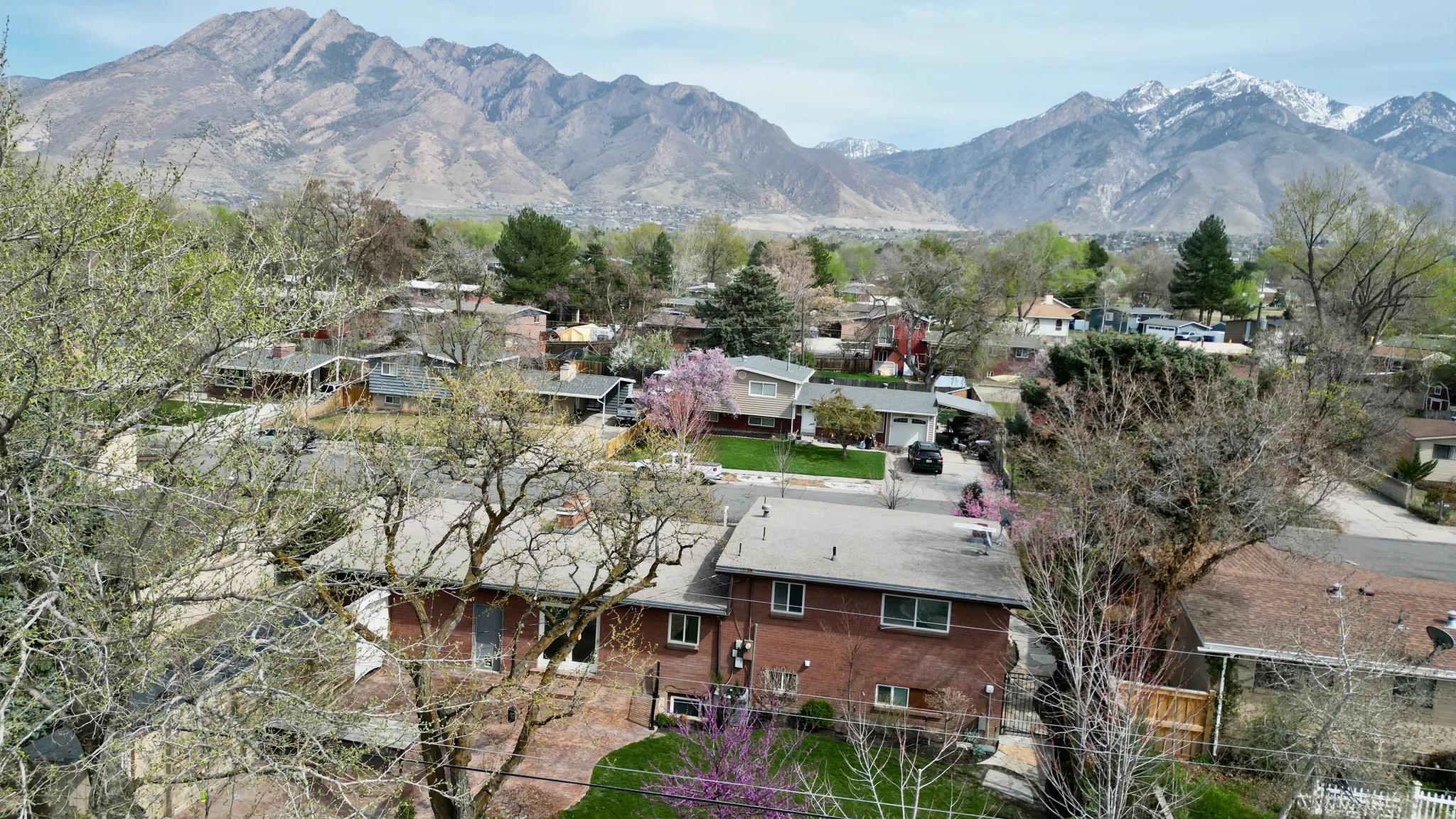 Aerial view of residential area featuring a mountain backdrop