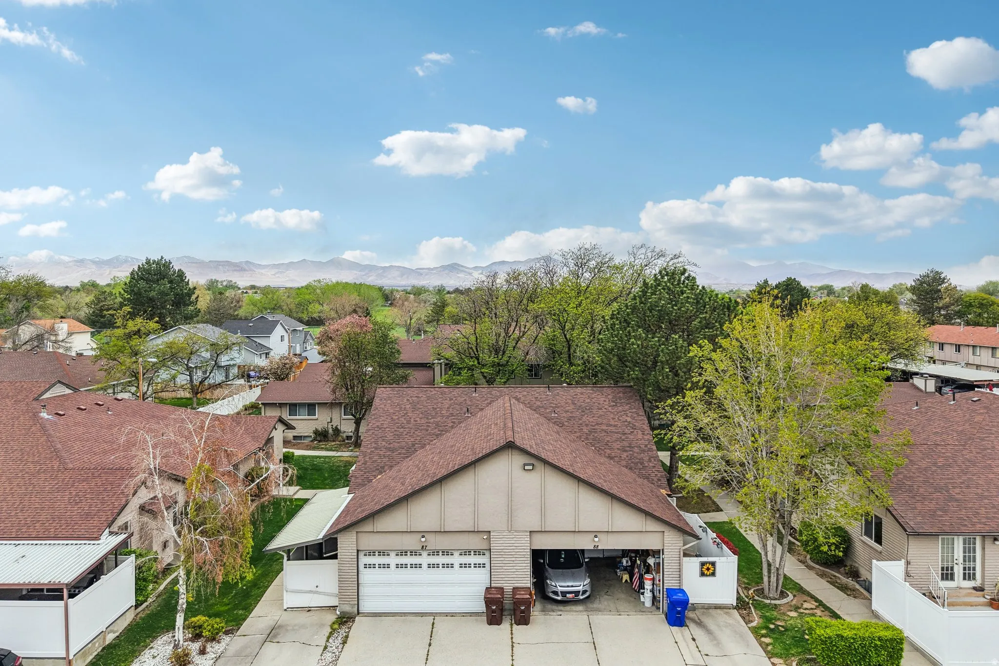 Aerial perspective of suburban area featuring a mountain backdrop