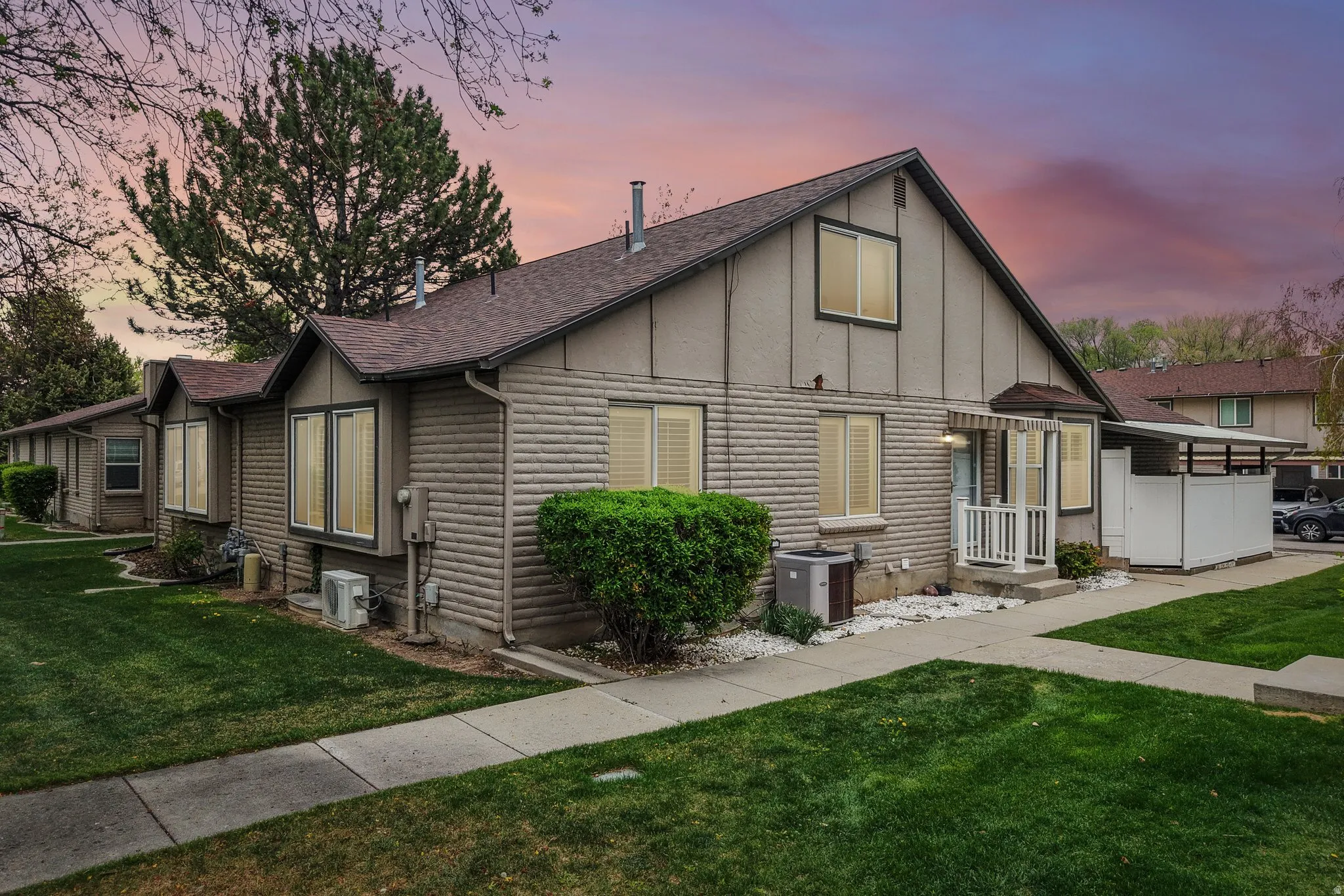 View of front of property featuring a front yard, a shingled roof, and board and batten siding