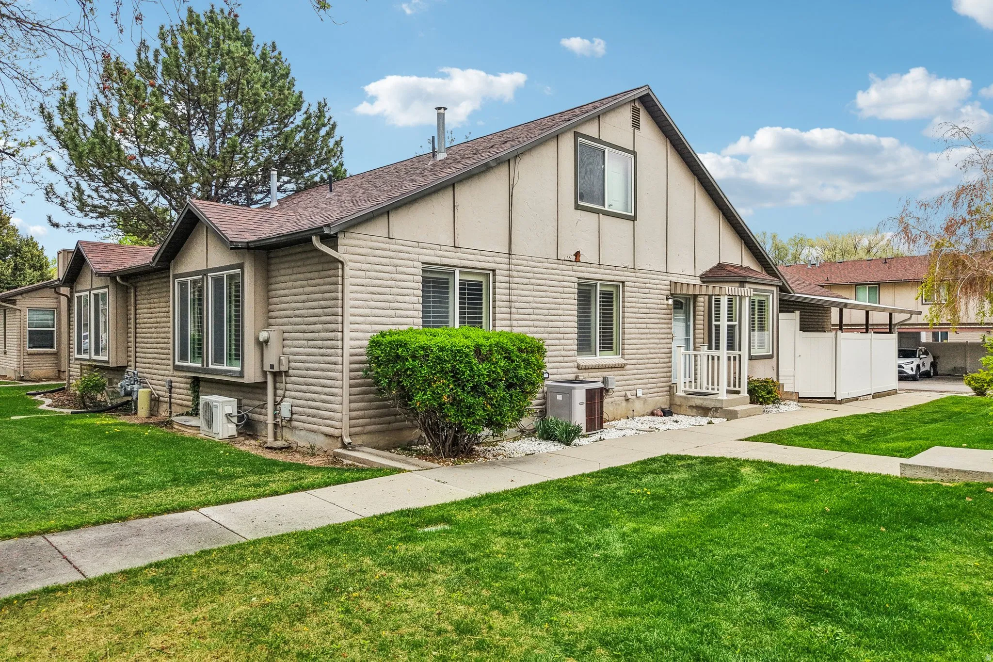 View of side of home with a lawn and a shingled roof