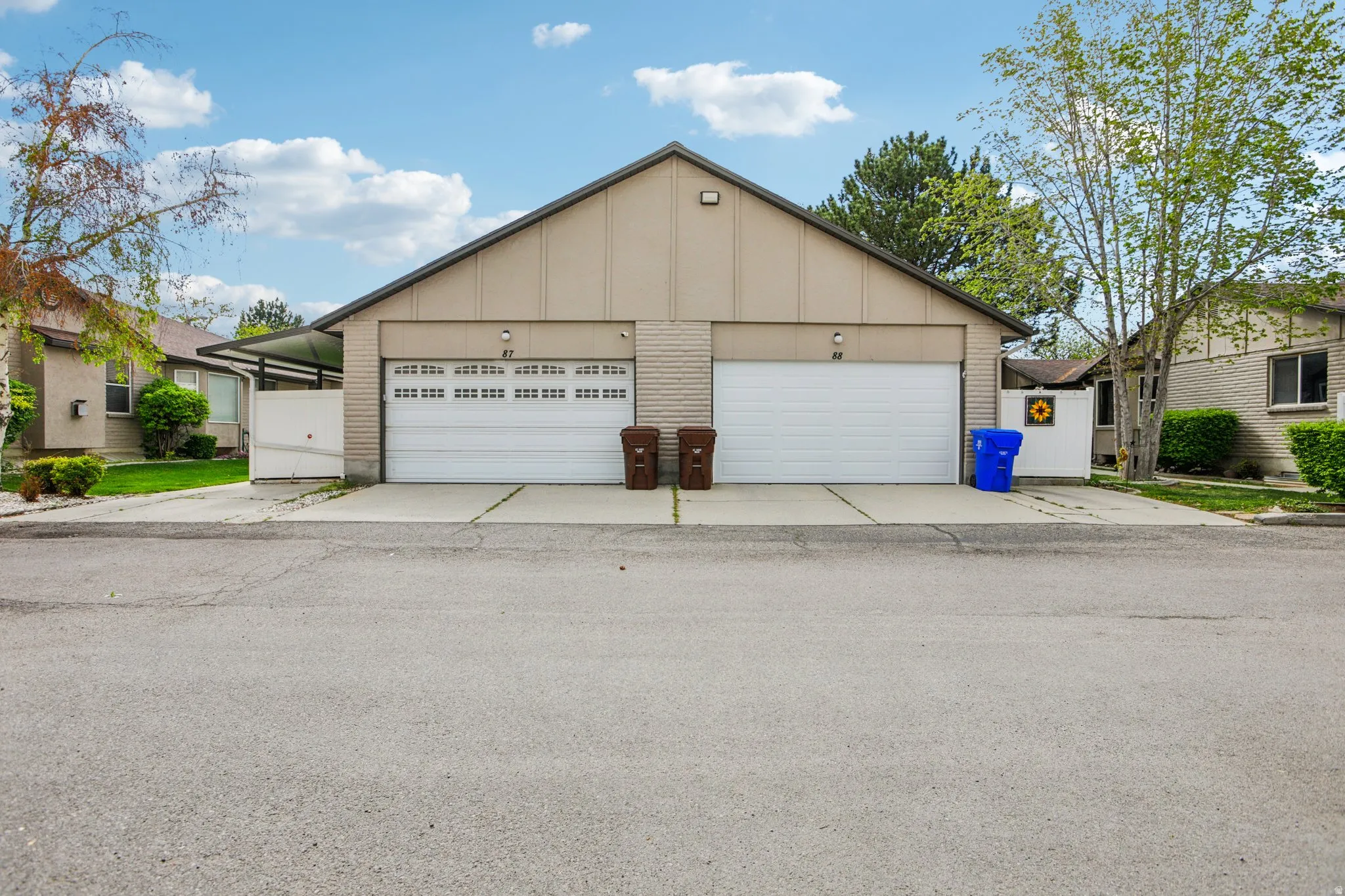 View of front of home featuring board and batten siding, brick siding, and a garage