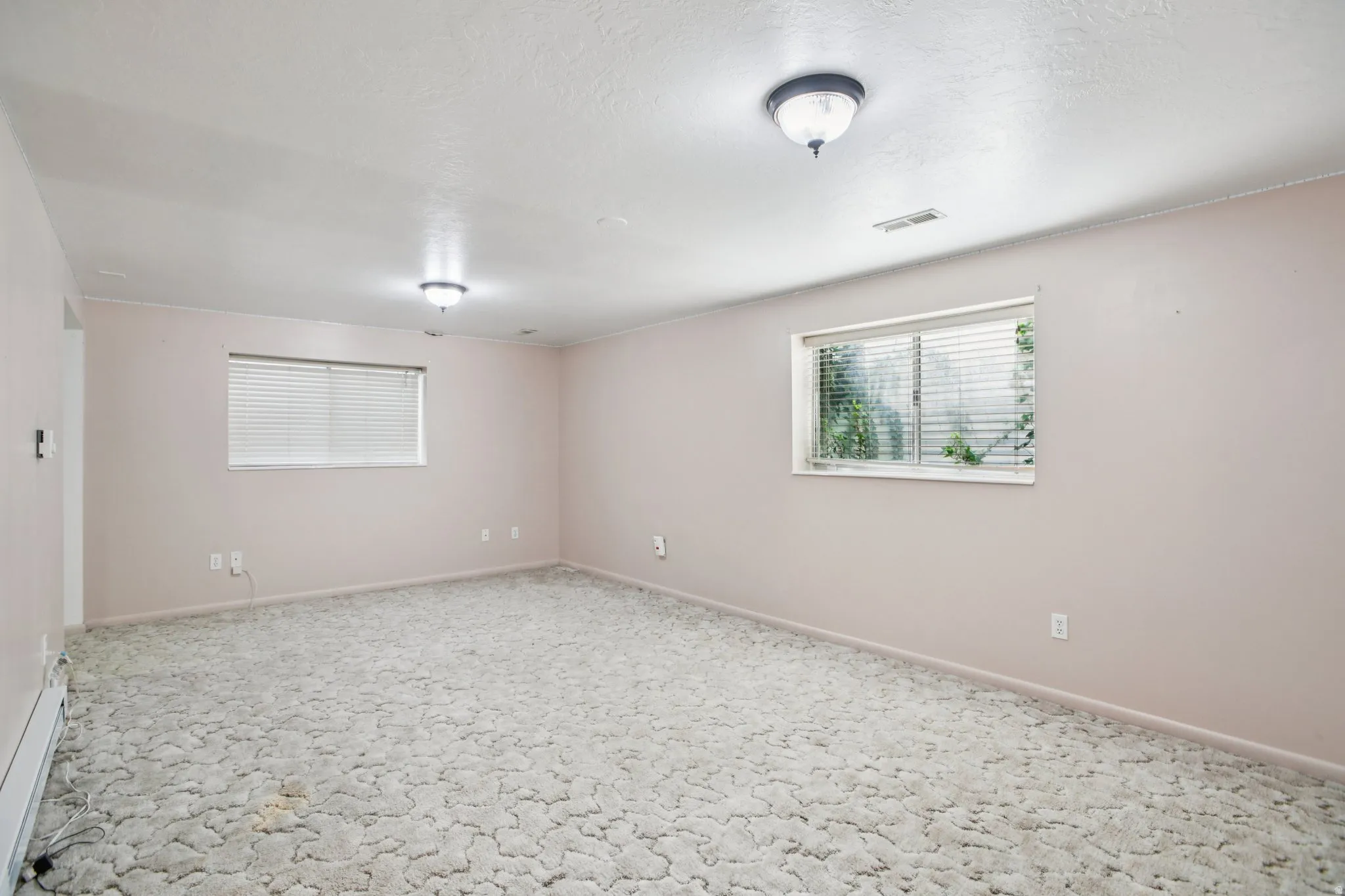 Carpeted empty room featuring a textured ceiling