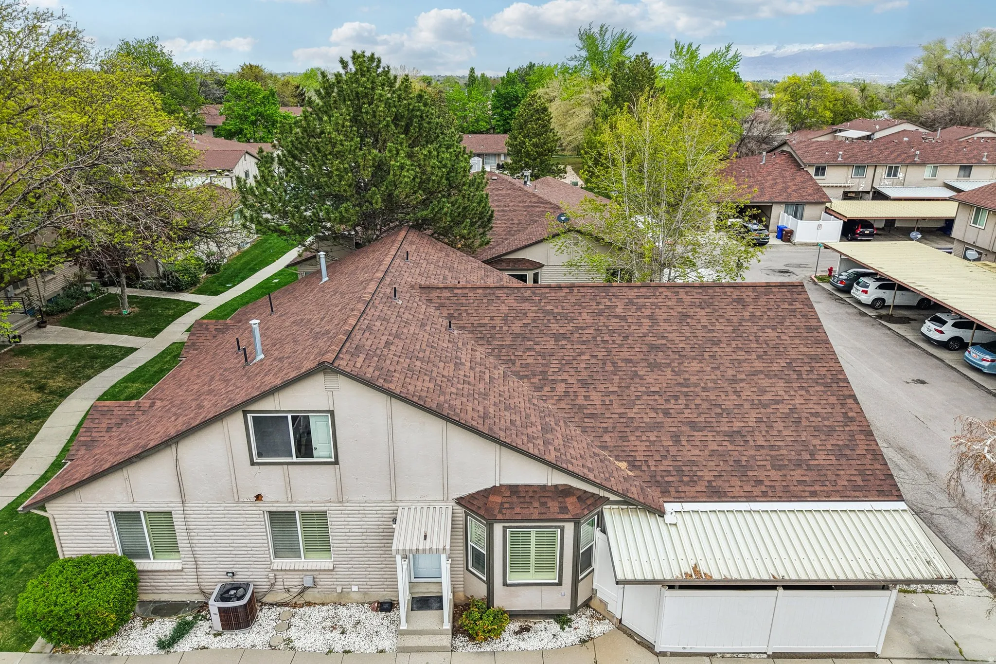 Rear view of property featuring a shingled roof, board and batten siding, and a residential view