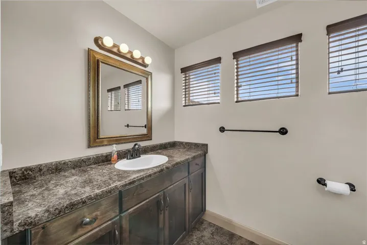 Bathroom with vanity and baseboards