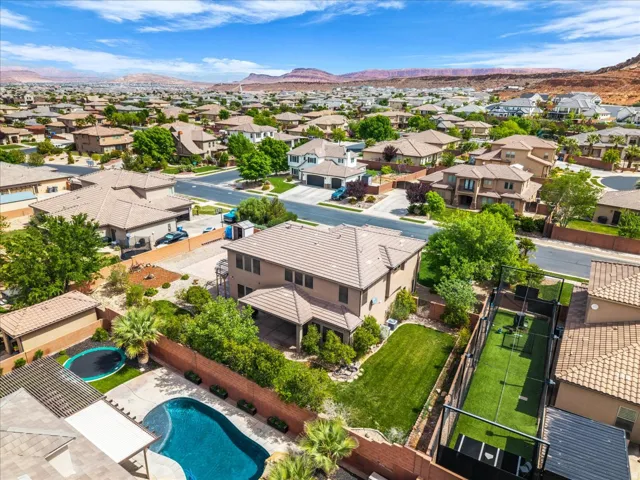 Aerial perspective of suburban area featuring mountains and a pool