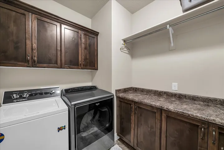Laundry area featuring cabinet space and washer and dryer