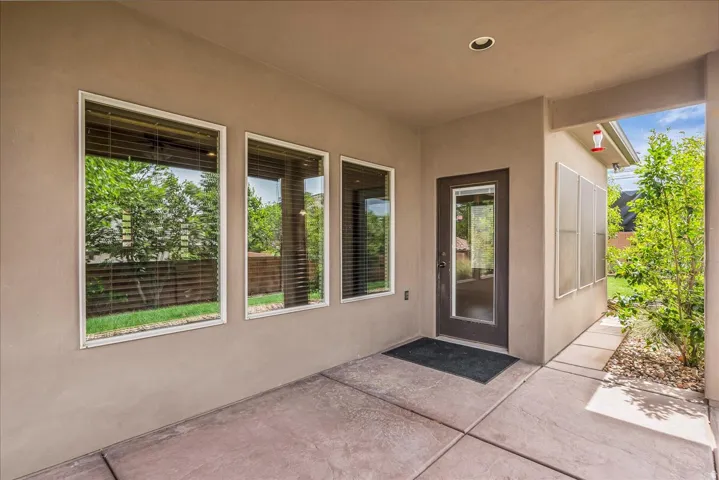 Entrance to property featuring stucco siding and a patio area