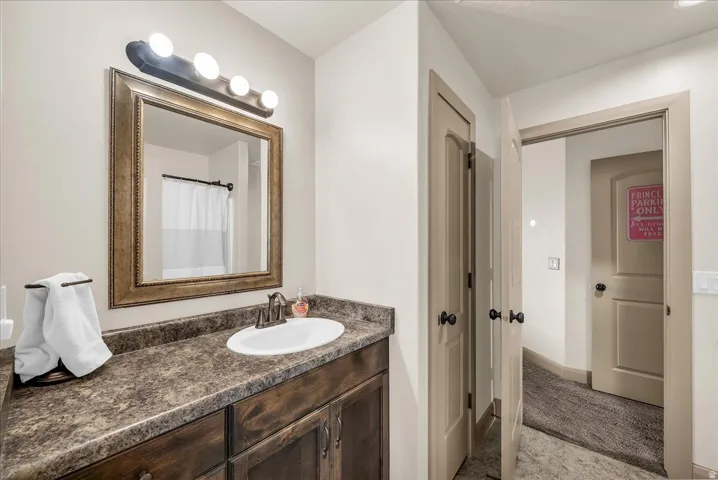Full bath with vanity and curtained shower