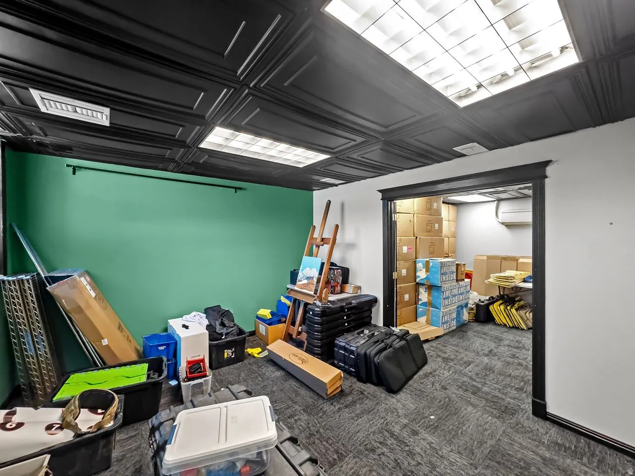 Basement with dark carpet and an ornate ceiling