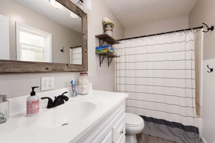 Bathroom featuring vanity, a textured ceiling, and dark wood-type flooring