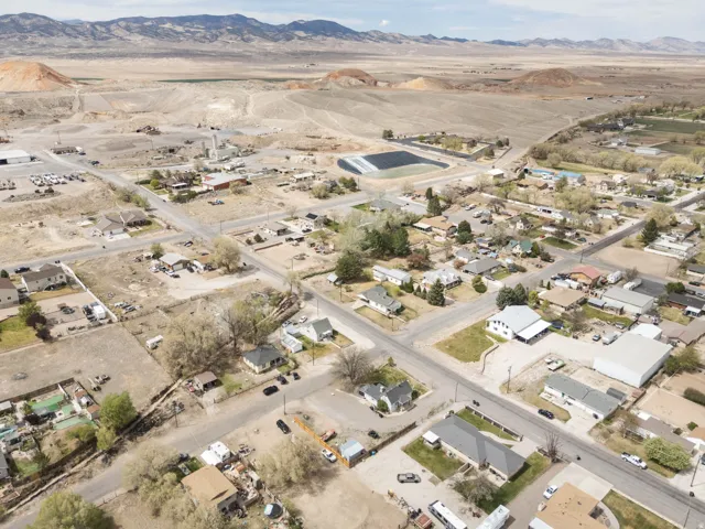 Overview of rural landscape with nearby suburban area and a mountainous background