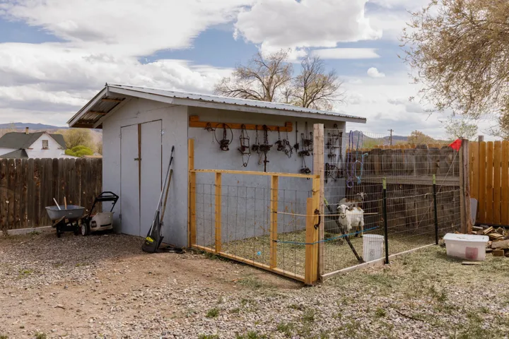 View of shed with a fenced backyard and exterior structure