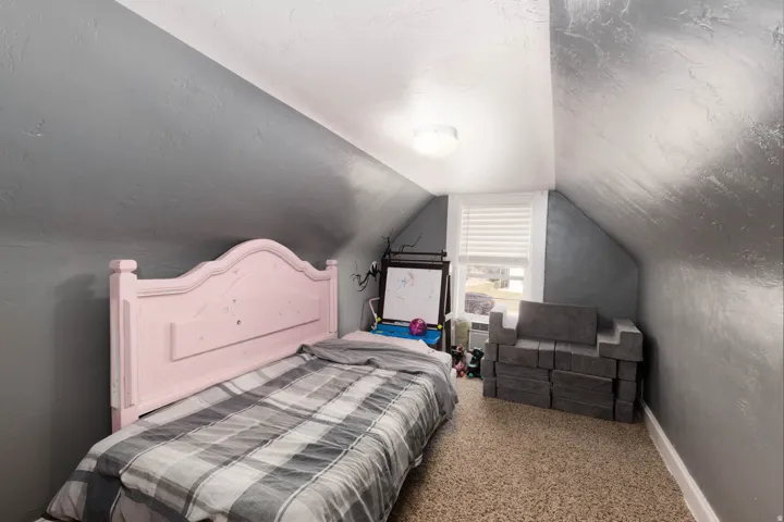 Bedroom featuring light colored carpet and baseboards