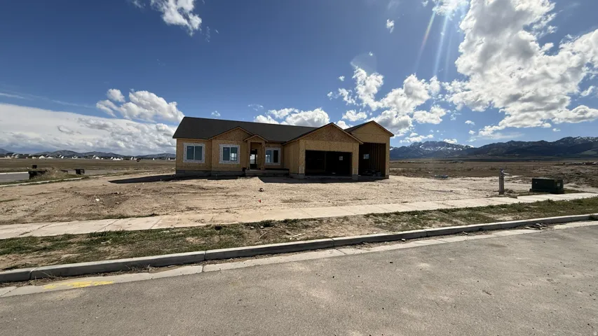 Property under construction with a mountain view and a garage