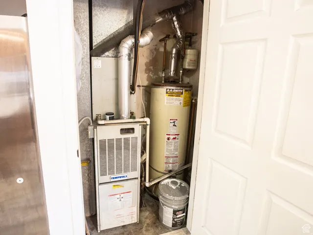 Utilities featuring heating unit and gas water heater