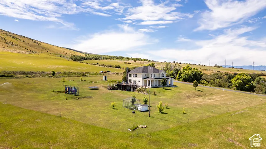 Expansive property featuring a two-story home with a wrap-around porch and elevated deck
