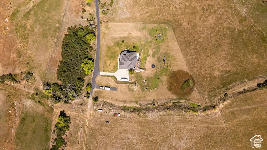 Aerial perspective showcasing a single-story residence with a multi-gabled roof and an attached garage
